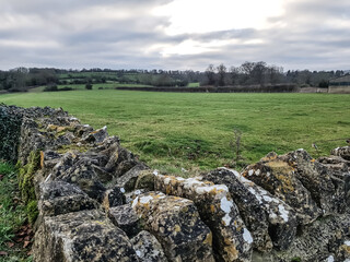 Stone wall corner in the field in countryside bourton on the water England UK