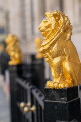 Gilded golden lions sitting on top of the metal railings outside the Law Society at Chancery Lane, London, England - 2