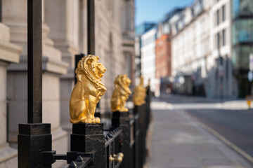 Gilded golden lions sitting on top of the metal railings outside the Law Society at Chancery Lane,...