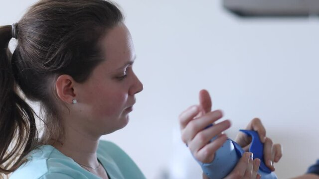 nurse tigthing a armbracer to a patient female