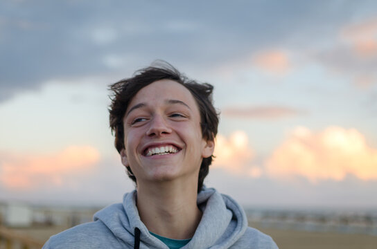 Smiling Teenage Boy Looking Away At Beach