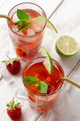 Strawberry mojito with lime and mint on the white wooden
