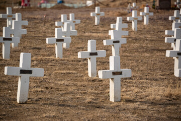 White stone crosses head stones at a cemetery graveyard in Colorado, USA