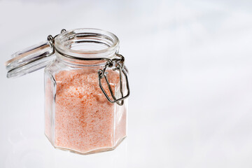Himalayan pink salt in a glass jar - White background