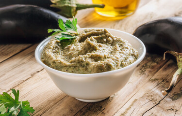 Traditional arabian eggplant dip baba ganoush on rustic wooden table