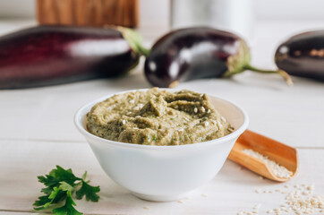 Traditional arabian eggplant dip baba ganoush on white wooden table