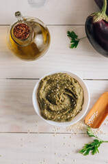 Traditional arabian eggplant dip baba ganoush on white wooden table
