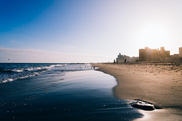 Beach with the city view, during the sunset