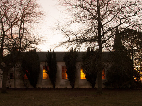 Rundown Church Glowing Windows At Sunset