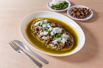 Corn huarache with beef and green sauce. Huarache is a dish of Mexican street food