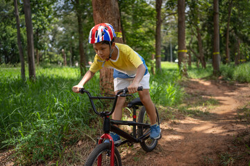 Obraz premium Asian boy is training for a happy mountain biking.