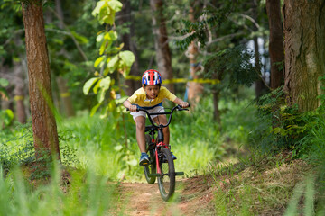 Naklejka premium Asian boy is training for a happy mountain biking.