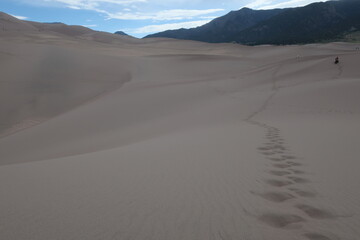 Fototapeta na wymiar Footsteps through the sand