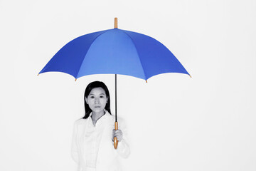 Businesswoman holding a blue umbrella