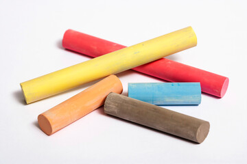 Color pieces of chalk on white background