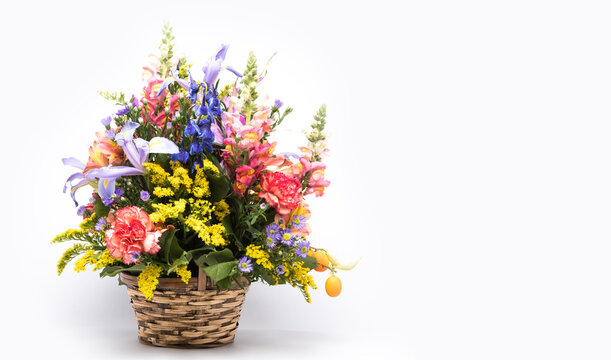 bouquet of bright flowers in basket isolated on white background. Mothers Day or Valentines Day Concept.  Copy Space