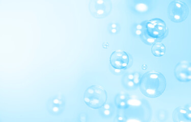 Clear blue soap bubbles float in the air. Abstract blur background.