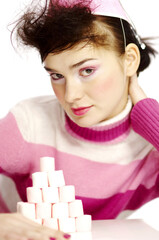 Woman in party hat posing in front of a stack of marshmallows