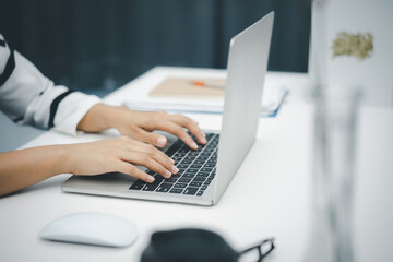 Female hands using laptop computer at home. Work from home concept