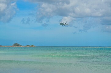 Fototapeta na wymiar Jet aircraft in final Approach for landing at Caribbean island