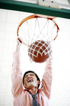 Businessman Doing A Slam Dunk