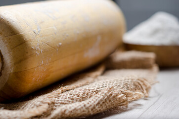 Bread prepared with a crust made in the oven with your own hands on a wooden table. flour and bakery artifacts