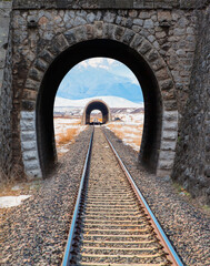 Old train brick tunnel with railway in a mountain