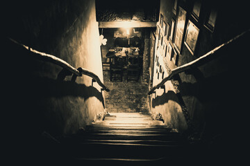 Dramatic point of view of scary stairs from upside into darkness of interior of old pub