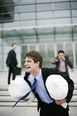 Businessman chasing after a thief