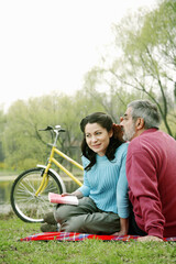 Man whispering a little something into his wife's ear