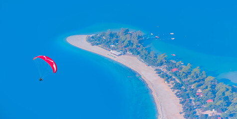 Paraglider flies in the sky - Panoramic view of amazing Oludeniz Beach And Blue Lagoon, Oludeniz beach is best beaches in Turkey - Fethiye, Turkey