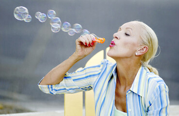 Woman blowing soap bubbles