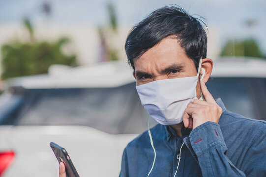 Asian man are call phone use face mask in city