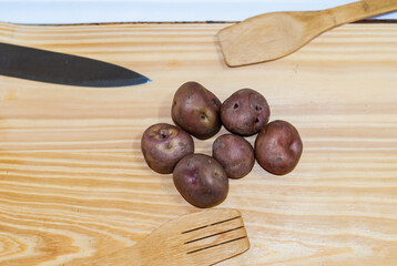 regional potatoes from the Andes at a market in Peru, Bolivia, Argentina, south america on a wooden table. Selective focus