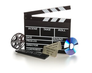 Single, black, open movie clapper or clapper-board with dvd movie disc, film reel, remote control and movie theatre tickets on white - digital movie, home cinema or movie night concept