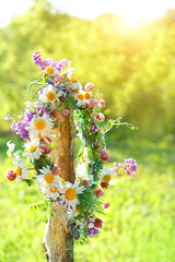 rustic wildflowers wreath. summer flower wreath in garden, sunny day. Farm lifestyle. Summer Solstice Day, Midsummer, floral traditional decor.