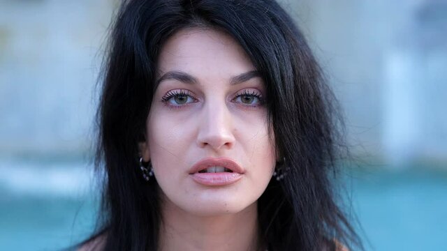 attractive young woman staring at camera with sensual look - outdoors