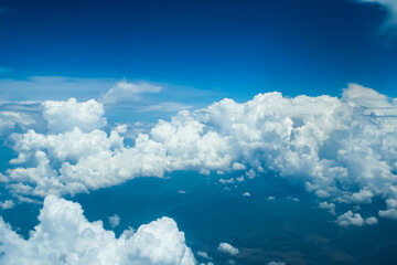 Naklejka na ściany i meble Cumulus clouds on a blue sky floating above the land