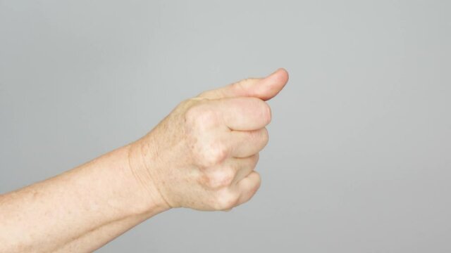 A view of the knuckles of a senior woman as she snaps her fingers rhythmically.