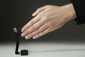 Businessman shaking hands with giant sized hands