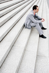 Businessman sitting on the staircase