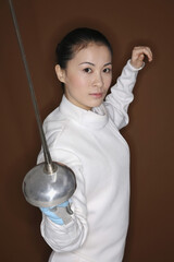 Woman in fencing suit with fencing foil