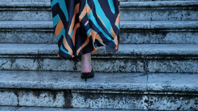 legs of elegant woman climbing the stairs of Janiculum fountain - slow motion