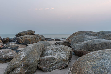 Fototapeta na wymiar beautiful coastal stones on the shore of the warm sea in summer