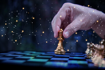 Businessman hand holding chess playing as strategy of business .