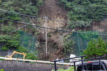 Landslide in Japan caused by heavy rain, a disaster where the cliff has collapsed onto the road close to local old people's houses.