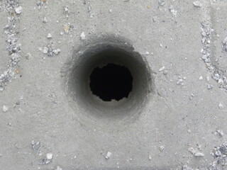 Abstract gray color concrete floor textured background with hole in center