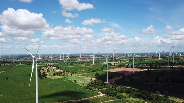Aerial of Windmills for electric power production with white cloud and blue sky at Huai Bong, Dan Khun Thot district, Nakhon Ratchasima THAILAND. renewable energy and save  environmental concept