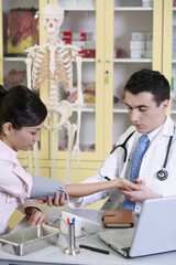 Obraz premium Doctor examining patient with blood pressure gauge