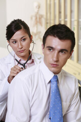 Doctor examining patient with stethoscope